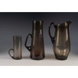 MID TWENTIETH CENTURY STYLISH SIX PIECE SMOKED GLASS WATER SET, comprising: SET OF FIVE HANDLED