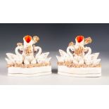 PAIR OF NINETEENTH CENTURY STAFFORDSHIRE POTTERY SPILL VASE GROUP, each heightened in colours and