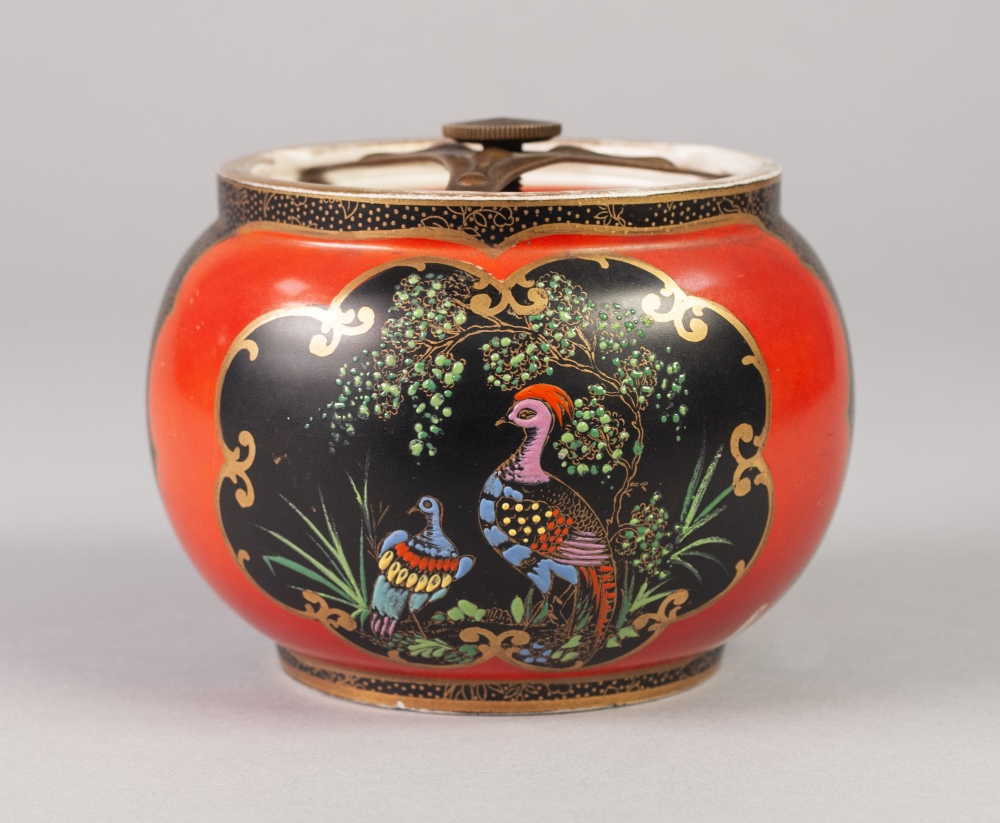 A WILTSHAW AND ROBINSON CARLTON WARE POTTERY TOBACCO JAR with securing in place airtight cover,