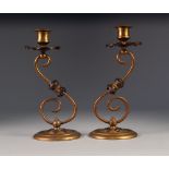 PAIR OF ARTS AND CRAFTS BRASS AND COPPER CANDLESTICKS, each of 'S' scroll form with urn shaped