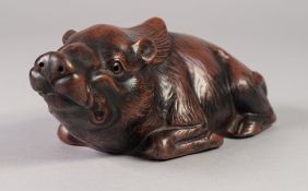 A JAPANESE EDO PERIOD RED STONEWARE MODEL OF A RECUMBENT BOAR, impressed seal mark, 8" (20.5cm)