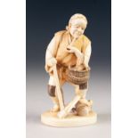 A GOOD JAPANESE MEIJI PERIOD ONE PIECE CARVED IVORY FIGURE of a peasant male, standing smoking a