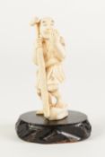 A SMALL JAPANESE MEIJI PERIOD ONE PIECE CARVED IVORY OKIMONO, of a peasant male holding an oar
