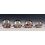 FOUR 'END OF DAY' GLASS PAPERWEIGHTS, including one with bubble inclusions, 3 ¼" (8.2cm) high and