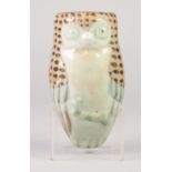 AN ORIENTAL CELADON GLAZE 'OWL' FORM WALL POCKET, accentuated with enamelling, 7" (17.5cm) long