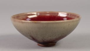 A SMALL CHINESE STONEWARE SONG DYNASTY (960-1279) STYLE BOWL the buff coloured glaze stained with