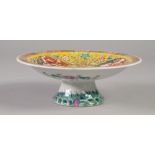 A CHINESE LATE QING DYNASTY PORCELAIN PEDESTAL SAUCER DISH polychrome enamelled with flowers, gourds