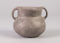 INTERESTING, POSSIBLY ANCIENT TWO HANDLED BURNISHED CLAY POT, 3 ½" (9cm) high