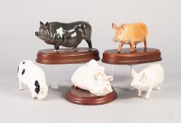 FIVE BESWICK POTTERY MODELS OF PIGS, comprising: two fixed to wooden stands, VIETNAMESE POT BELLY