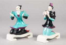 AN UNUSUAL PAIR OF EARLY 1950's ROYAL WORCESTER PORCELAIN 'CHINOISERIE' FIGURES, both kneeling on