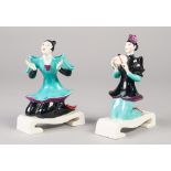 AN UNUSUAL PAIR OF EARLY 1950's ROYAL WORCESTER PORCELAIN 'CHINOISERIE' FIGURES, both kneeling on