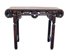 A CHINESE REPUBLIC PERIOD HUALI WOOD ALTAR TABLE, the rectangular top with scrolled ends terminating