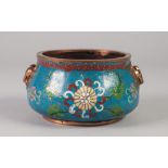 A CHINESE QING DYNASTY BRONZE AND CLOISONNE ENAMEL BOWL of squat ogee form cast with opposing