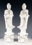 A PAIR OF TWENTIETH CENTURY CHINESE MIRROR IMAGE BLANC DE CHINE PORCELAIN FIGURES, of Guanyin,