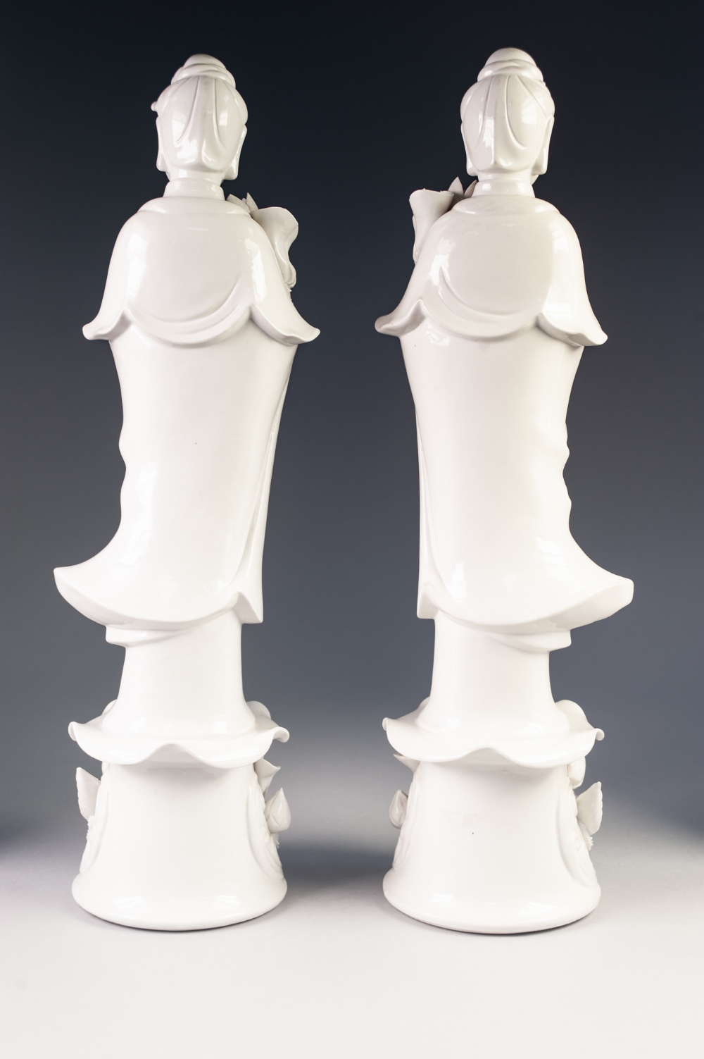 A PAIR OF TWENTIETH CENTURY CHINESE MIRROR IMAGE BLANC DE CHINE PORCELAIN FIGURES, of Guanyin, - Image 2 of 3