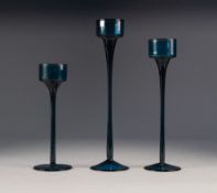 RONALD STENNET WILLSON FOR WEDGWOOD, GRADUATED SET OF THREE BLUE 'SANDRINGHAM' GLASS CANDLESTICKS,