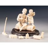 JAPANESE MEIJI PERIOD CARVED SECTIONAL IVORY GROUP, modelled as a street vendor and his son, 4 ¼" (