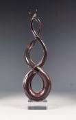 MURANO PALE PINK CASED GLASS 'LOVE KNOT' SCULPTURE, raised on a clear glass oblong base, unmarked,