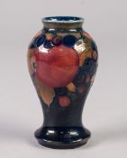 WILLIAM MOORCROFT POMEGRANATE PATTERN TUBE LINED POTTERY SMALL VASE, of baluster form, decorated