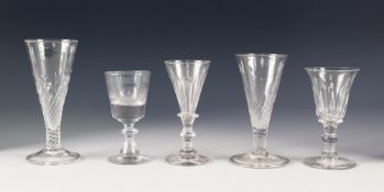 FIVE ANTIQUE DRINKING GLASSES, comprising: TWO ALE GLASSES, both with part wrythen fluted bowls, one
