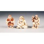 THREE JAPANESE MEIJI PERIOD CARVED IVORY NETSUKE, comprising: TWO STREET VENDORS, one heightened