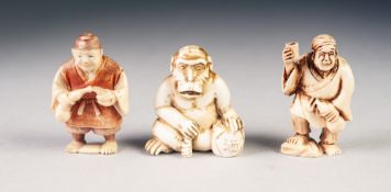THREE JAPANESE MEIJI PERIOD CARVED IVORY NETSUKE, comprising: TWO STREET VENDORS, one heightened