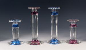 TWO GRADUATED PAIRS OF STYLISH MODERN MOULDED GLASS CANDLESTICKS, of matching design, one pair