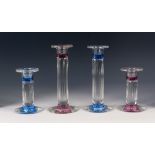 TWO GRADUATED PAIRS OF STYLISH MODERN MOULDED GLASS CANDLESTICKS, of matching design, one pair