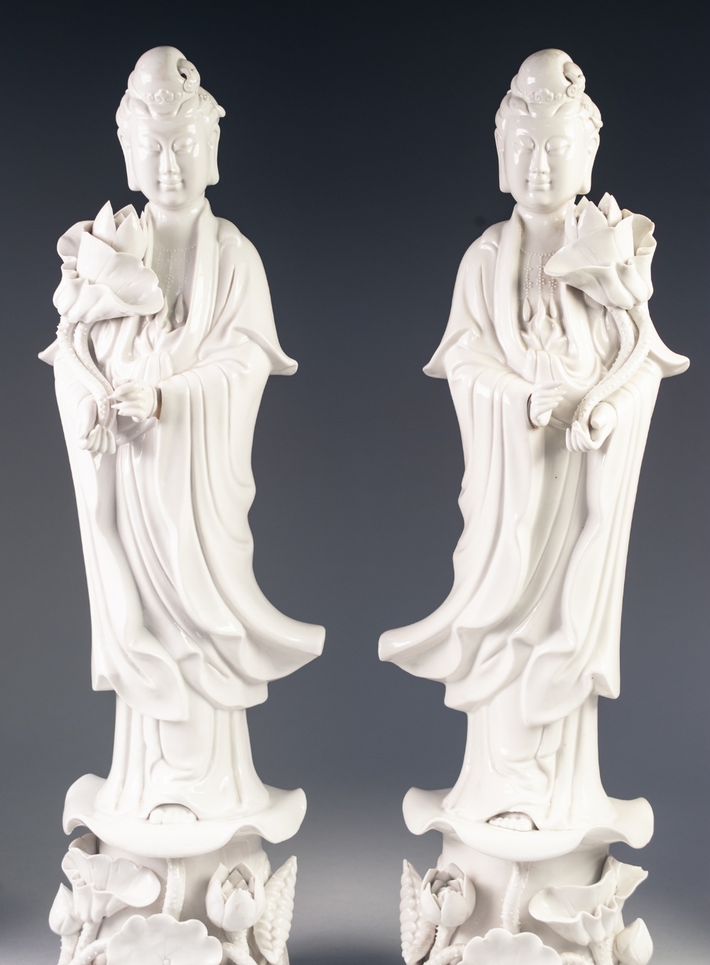 A PAIR OF TWENTIETH CENTURY CHINESE MIRROR IMAGE BLANC DE CHINE PORCELAIN FIGURES, of Guanyin, - Image 3 of 3