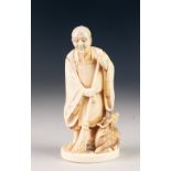 A GOOD JAPANESE MEIJI PERIOD ONE PIECE CARVED IVORY FIGURE, a bearded man holding a bamboo handled