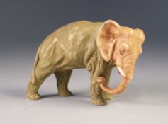 ROYAL DUX STYLE PORCELAIN MODEL OF AN ELEPHANT, painted in muted tones and git and modelled