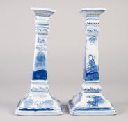 PAIR OF MODERN BLUE AND WHITE PORCELAIN CANDLESTICKS, of square form, outlined and washed in the