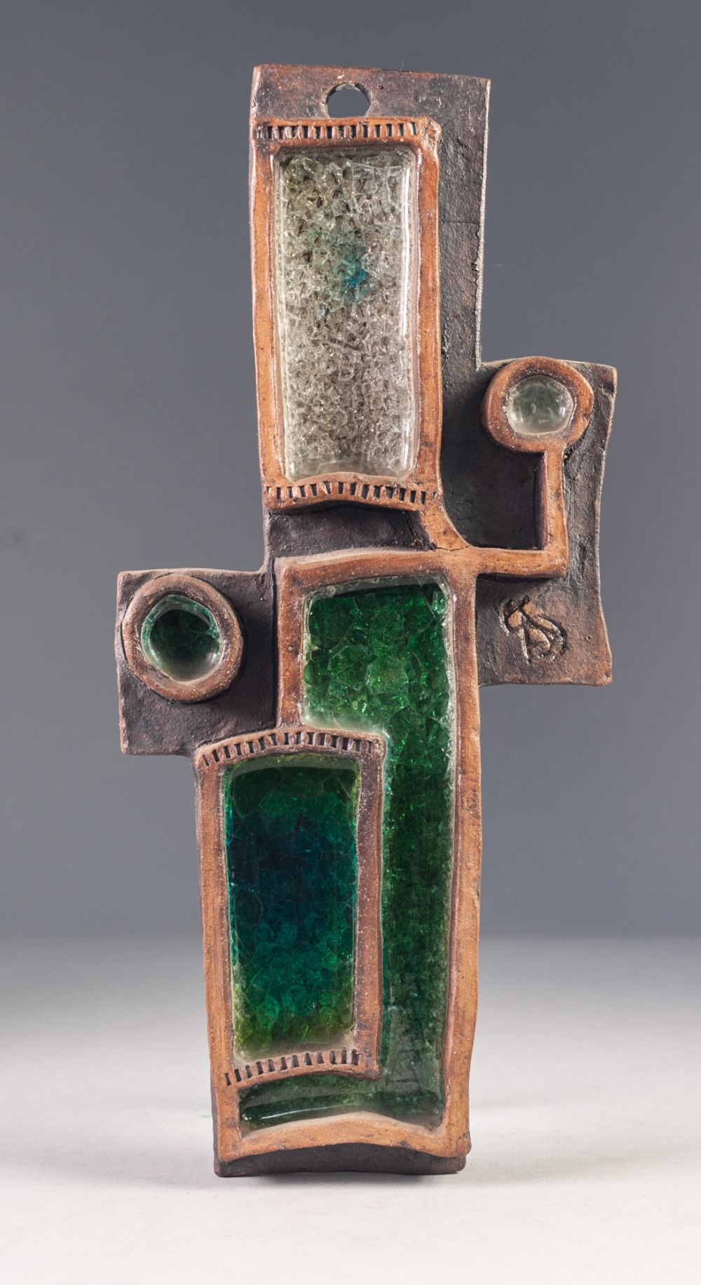 MODERN STUDIO POTTERY AND GLASS WALL HANGING, of cross form with five shaped compartments containing