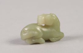 SMALL AGED CHINESE CELADON JADE MODEL OF A RECUMBENT HORSE 2" (5cm) long