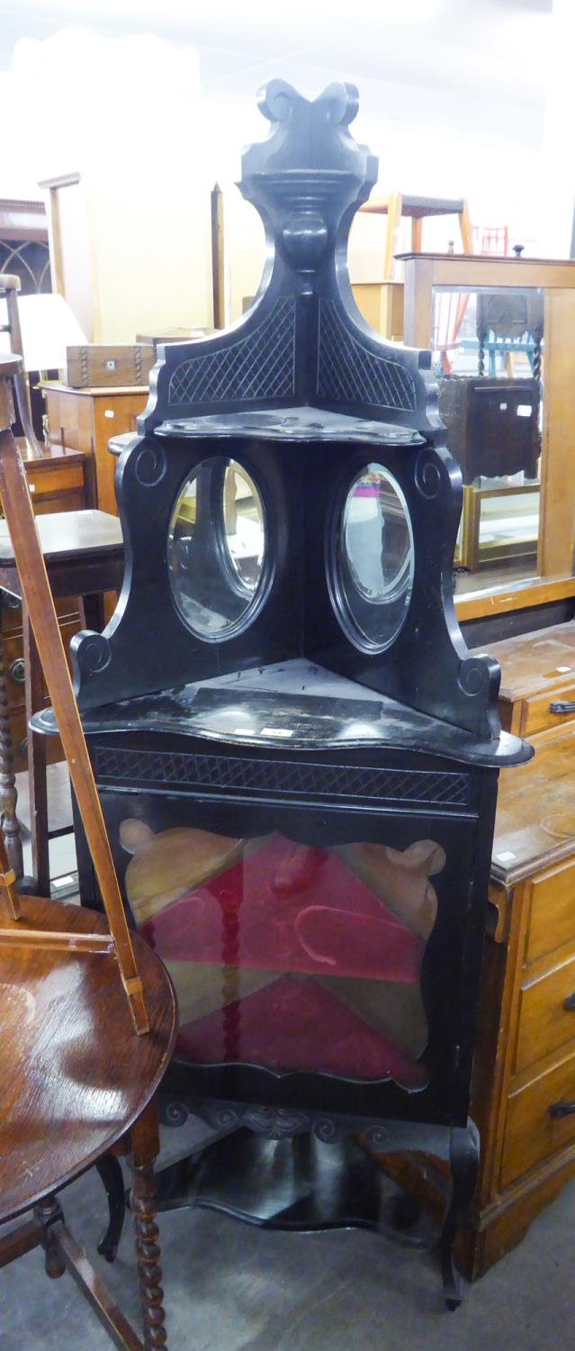 EBONISED CORNER DISPLAY UNIT HAVING TWO MIRRORS ABOVE A GLAZED DOOR