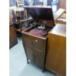 A FREESTANDING NARROW GRAMOPHONE CABINET WITH LIFT-UP LID (not working)