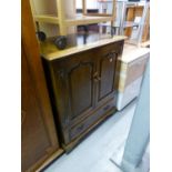 A GOOD QUALITY DISTRESSED OAK TV CABINET, TWO PANEL DOORS OVER A DROP-FRONT SECTION