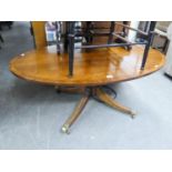 A REGENCY STYLE MAHOGANY LARGE OVAL, LOW OCCASIONAL TABLE, ON SHORT COLUMN AND SWEPT QUARTETTE