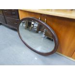 A LARGE FRAMED BEVELLED EDGE OVAL WALL MIRROR