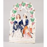 NINETEENTH CENTURY STAFFORDSHIRE FLAT BACK POTTERY 'VICTORIA AND ALBERT' ARBOUR GROUP, painted in