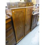 AN OAK TWO DOOR CUPBOARD WITH FITTED SHELVES