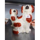 A PAIR OF NINETEENTH CENTURY STAFFORDSHIRE POTTERY MANTEL DOGS