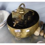 AN OVAL BRASS JARDINIERE WITH LIONS MASK AND RING HANDLES, PAW FEEET AND AN ORIENTAL BRASS