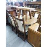 AN ERCOL TEAK EXTENDING DINING TABLE, RAISED ON CENTRAL TURNED COLUMN TO FOUR SPLAYED LEGS, AND FOUR