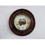 A SMALL WALNUT FRAMED ANEROID BAROMETER