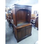 A REPRODUCTION MAHOGANY ARCH TOPPED DISPLAY STAND ON CUPBOARD BASE
