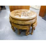 A NEST OF SOUTH EAST ASIAN CIRCULAR PROFUSELY CARVED TABLE WITH FOUR NESTING TABLES