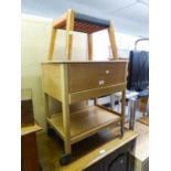 A TEAK SEWING TABLE WITH LIFT-UP LID AND DRAWER ON CASTORS WITH SEWING ACCESSORIES AND A SMALL