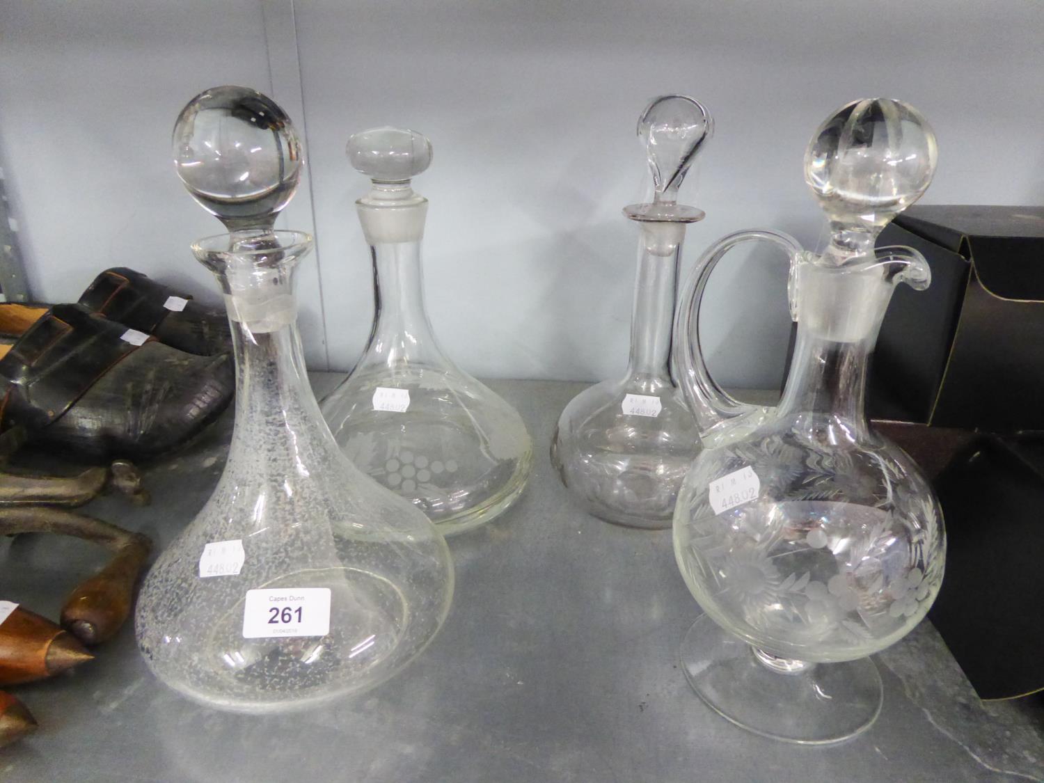 A GLASS CLARET JUG, TWO SHIPS DECANTERS AND A GLOBE DECANTER (4)