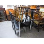 A MODERN GLASS AND CHROME DINING TABLE WITH FOUR BLACK LEATHER BACK AND SEATED CHAIRS (5)